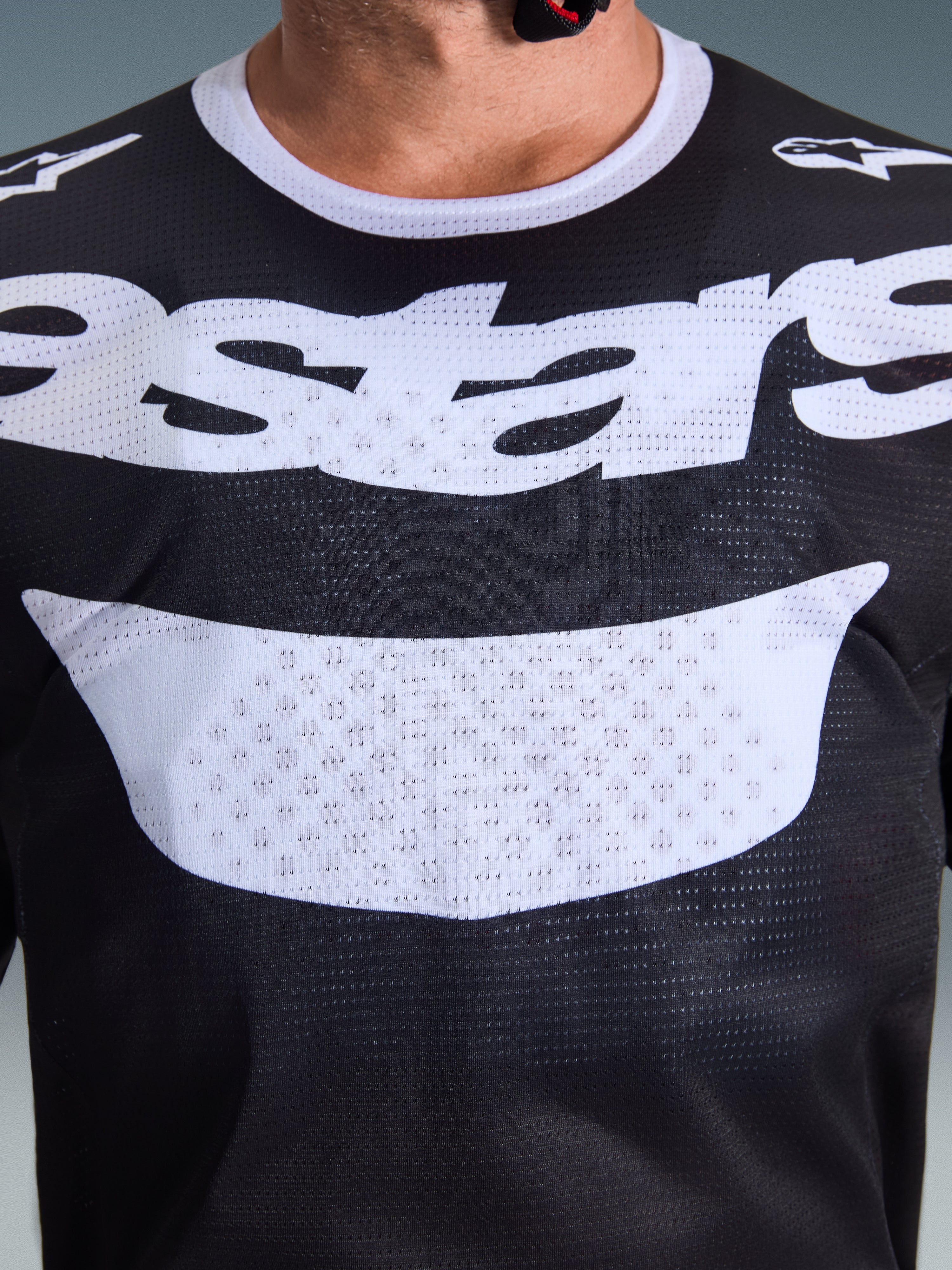 Alpinestars 2026 Racer Air Riway Jersey, Motocross Jersey, Black and White, close-up of chest showing large white graphic and breathable mesh construction, white collar and shoulder logos