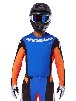 Alpinestars 2025 Techstar Melt Jersey, Motocross Jersey, Blue and Orange with black side panels, worn with black helmet and blue goggles, featuring breathable laser-cut perforations on chest, athletic race fit for off-road performance