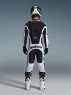 Rear view of a motocross rider wearing the 2026 Racer Riway Gear Set in Black and White, featuring a black jersey with white accents, white pants with bold 'astars' branding on the seat, black helmet, white boots, and black gloves, complete professional off-road racing outfit.