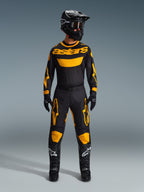 Motocross rider wearing the 2026 Racer Riway Jersey in Yellow and Black, coordinated with matching pants, black helmet, and black boots with white Alpinestars logos, full gear set for off-road racing.