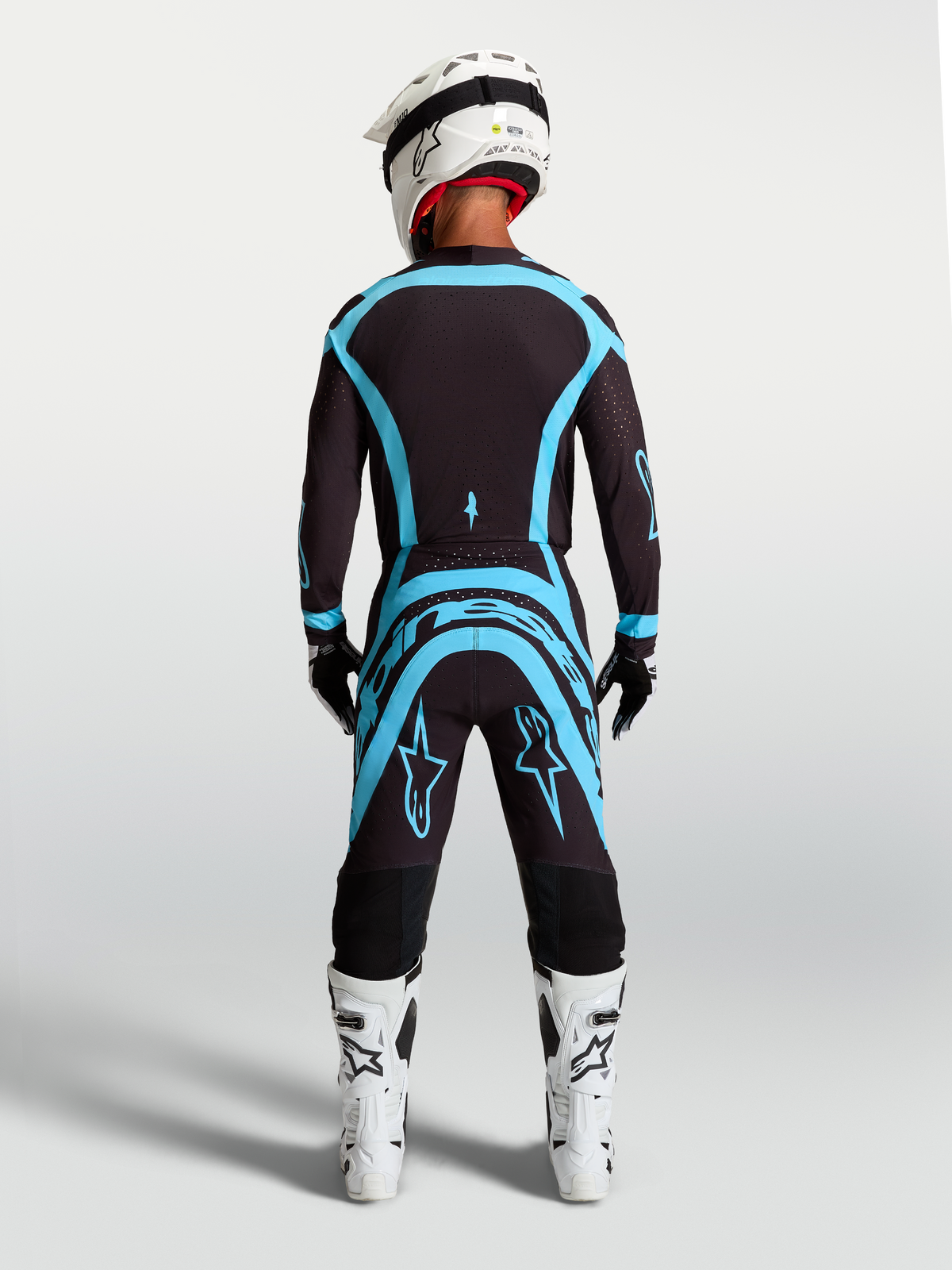 Alpinestars Supertech Vesta Gear Set, Motocross-Trikot und Hose in Schwarz und Türkis, Rückansicht, athletische Passform.