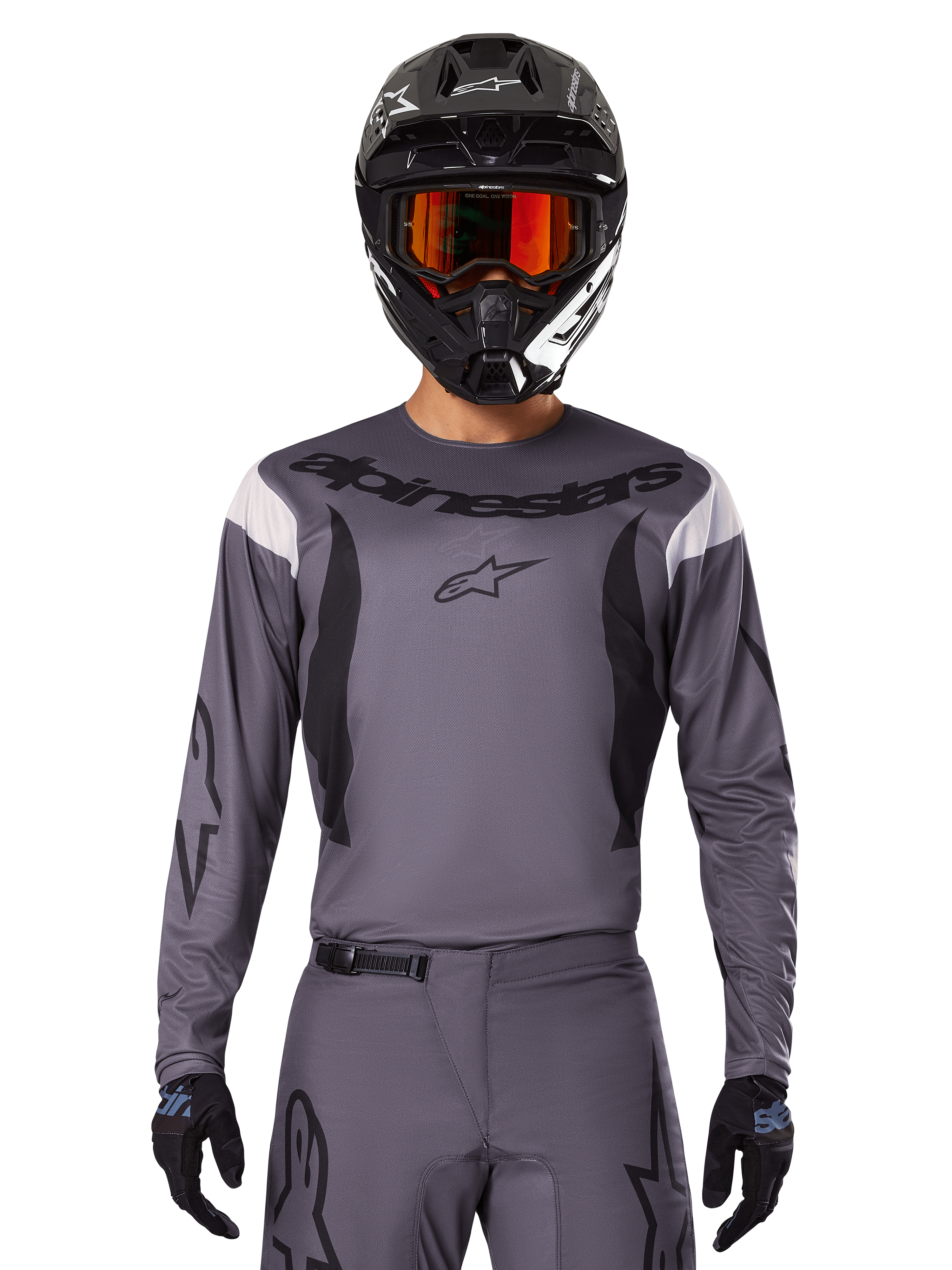 Motocross rider wearing the 2025 Fluid Haul Jersey and Gear Set, Gray with black and white accents, featuring long sleeves and bold branding, black helmet with orange goggles, and black gloves, coordinated outfit for off-road racing