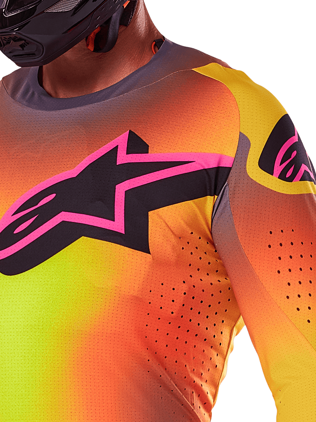 Nahaufnahme des Alpinestars 2025 Supertech Lipan Trikots in Gelb-Rosa, mit einem lebhaften Farbverlauf-Design, einem großen schwarzen Stern-Logo mit rosa Rand auf der Brust und sichtbaren lasergeschnittenen Perforationen für verbesserte Luftzirkulation.