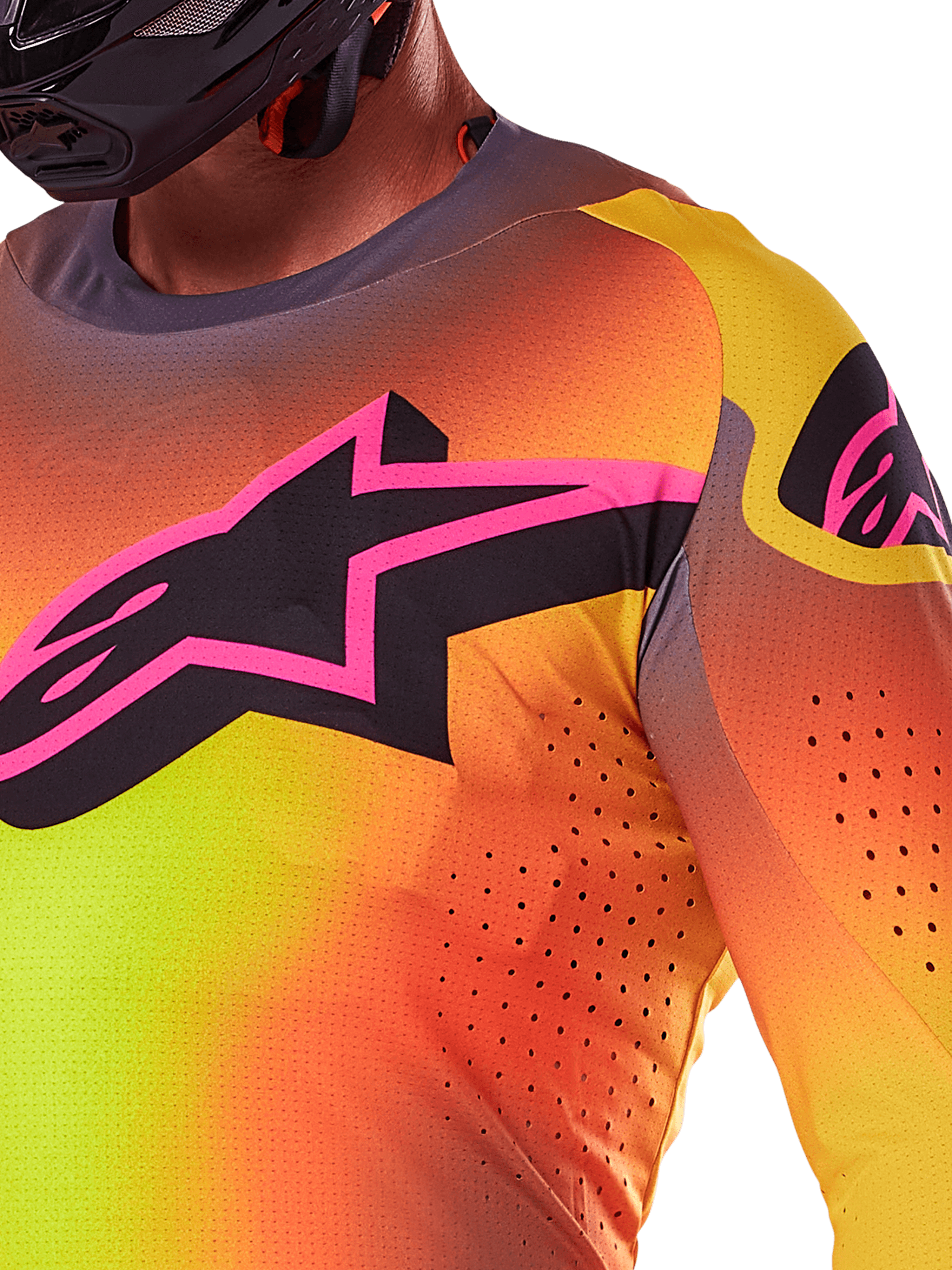 Nahaufnahme des Alpinestars 2025 Supertech Lipan Trikots in Gelb-Rosa, mit einem lebhaften Farbverlauf-Design, einem großen schwarzen Stern-Logo mit rosa Rand auf der Brust und sichtbaren lasergeschnittenen Perforationen für verbesserte Luftzirkulation.