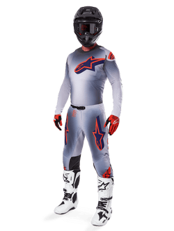 Alpinestars 2025 Supertech Lipan Gear Set, Motocross Racing Gear, Gray with Orange Fluo and Navy Blue star graphics, worn with a black helmet, red and black gloves, and white and black boots, complete professional off-road outfit with ventilated design