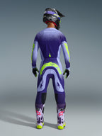 Motocross rider from behind wearing the Alpinestars 2026 Supertech Scenz Jersey in Purple Yellow Fluo, featuring a purple gradient and yellow branding, styled with matching motocross pants and purple boots, complete off-road racing kit.