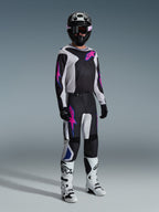 Alpinestars 2026 Fluid Grid Gear Set, motocross rider wearing black and white jersey and pants with pink and blue accents, black helmet, black gloves, and white boots, complete racing ensemble on a gray background