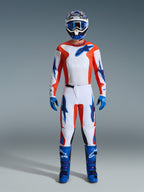 Alpinestars 2026 Fluid Grid Gear Set, Motocross rider wearing full gear, white jersey and pants with orange and UCLA blue accents, matching blue and white helmet with blue goggles, blue gloves, and blue motocross boots, coordinated off-road racing outfit