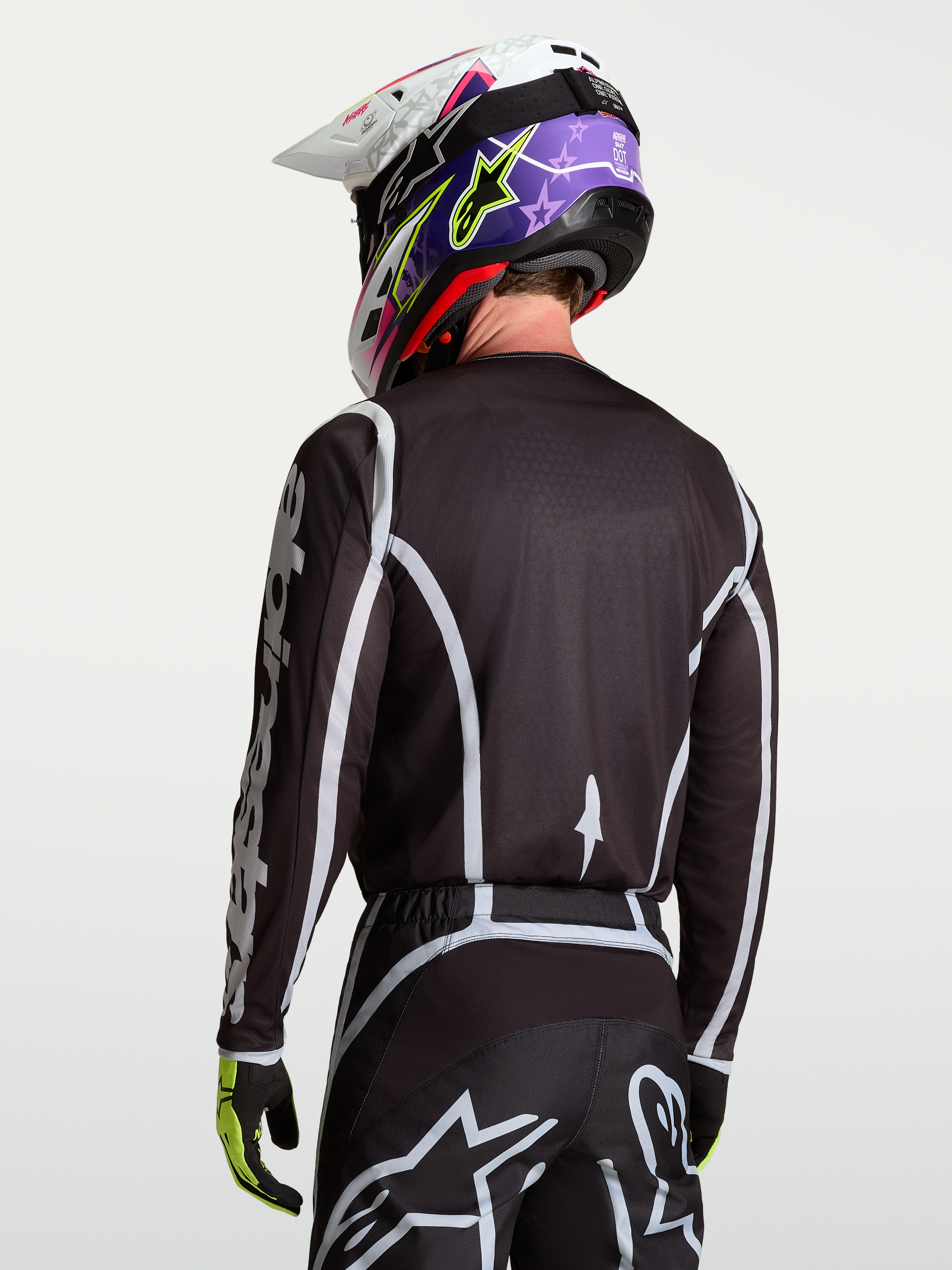 Alpinestars Fluid Apex V2 Trikot, Motocross-Oberteil für Herren, Rückansicht in Schwarz und Silber, feuchtigkeitsableitendes Polygewebe mit ergonomischem Schnitt.