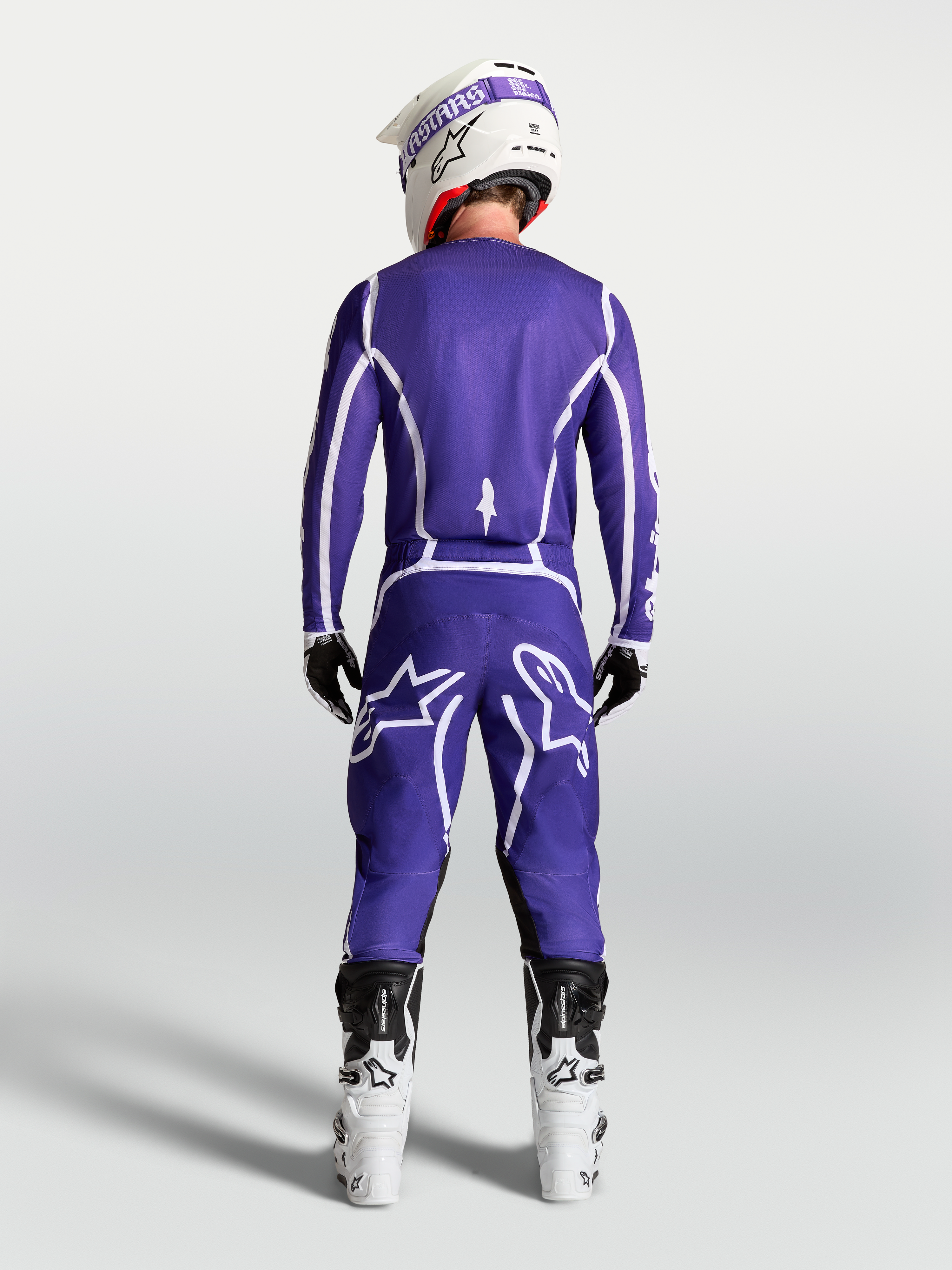 Alpinestars Fluid Apex V2 Jersey in Deep Blue and White, rear view on rider with matching motocross pants and white boots.