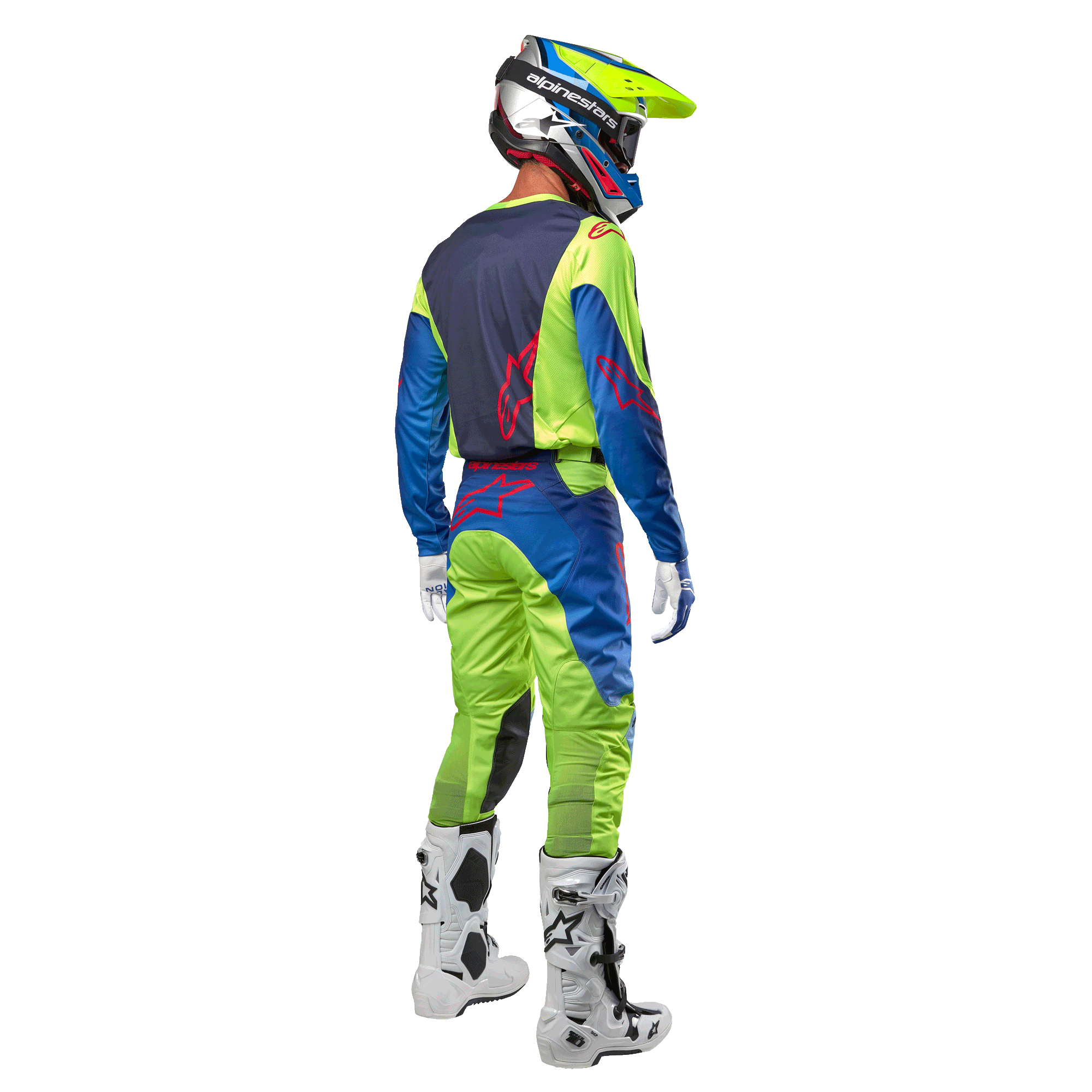 Motocross-Fahrer von hinten im Alpinestars 2024 Racer Hoen Trikot in Gelb Fluo und Blue Night Navy, passende Motocross-Hose und weiße Stiefel, zeigt das Rückendesign mit roten Logos, abgestimmtes Outfit für den professionellen Offroad-Rennsport
