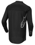 Alpinestars Fluid Graphite Jersey, Motocross-Trikot, Schwarz und Dunkelgrau, Rückansicht, mit großem grauem Alpinestars-Logo an der Seite und Ärmelgrafiken, leichtes feuchtigkeitsableitendes Textil für den Offroad-Rennsport