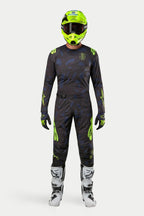 Alpinestars 2024 Techstar Rantera Jersey and Pants, Motocross racing gear set, Black Navy and Yellow Fluo, worn with a matching fluorescent yellow helmet and white boots, featuring bold yellow branding and technical mesh panels for off-road performance