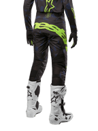 Alpinestars 2024 Techstar Rantera Pants, Motocross Pants, Black Navy and Yellow Fluo, back view, featuring bold neon yellow branding and mesh ventilation panels, worn with matching jersey and white boots, durable gear for motocross and off-road racing