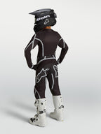 Alpinestars 2027 Jugend Fluid Apex V2 Motocross-Ausrüstungsset in Schwarz und Silber, Rückansicht mit weißen Stiefeln.