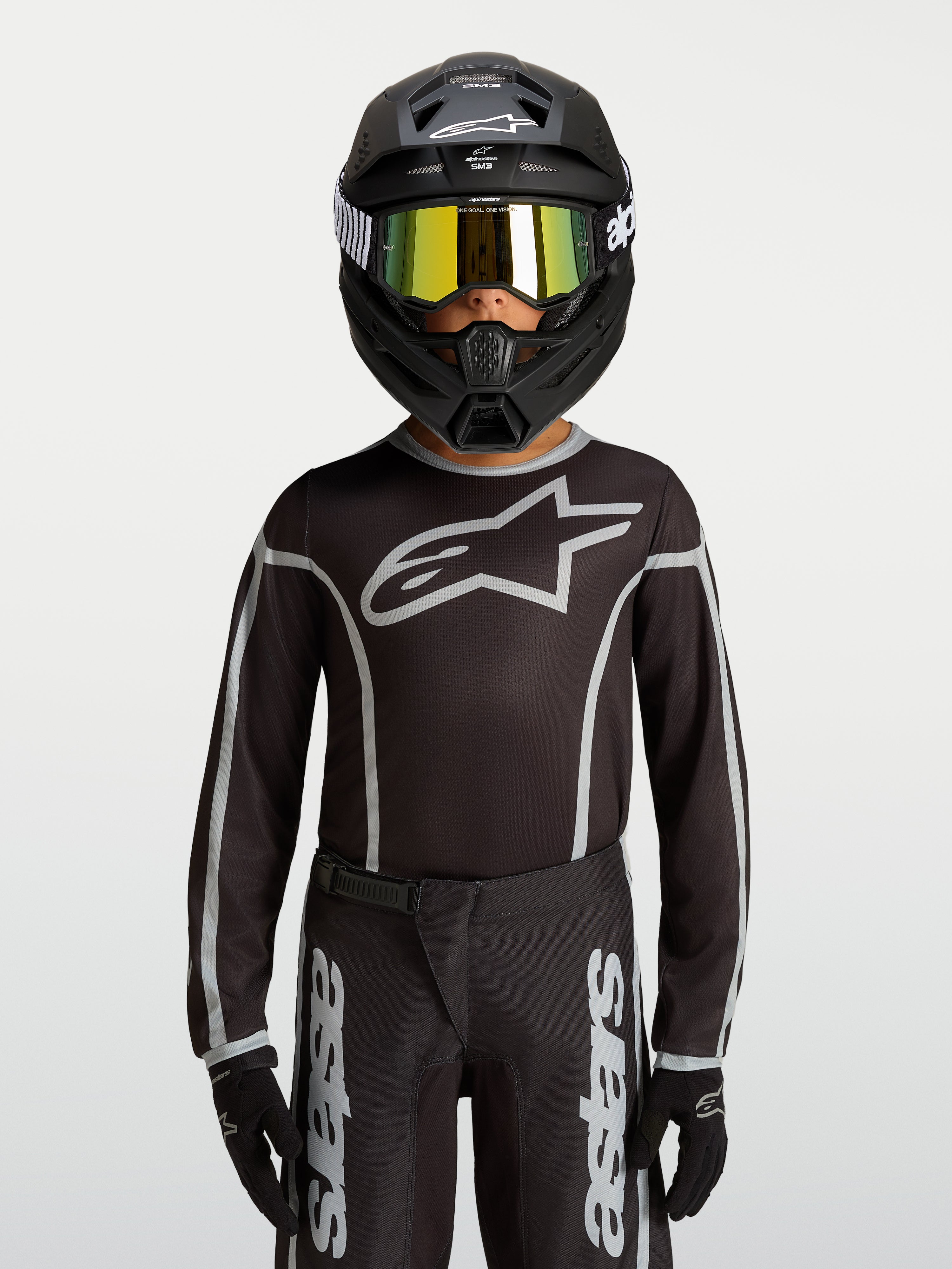 Alpinestars Fluid Apex V2 Jugend-Trikot, Motocross-Ausrüstung in Schwarz und Silber, ergonomische Passform aus Polygewebe.