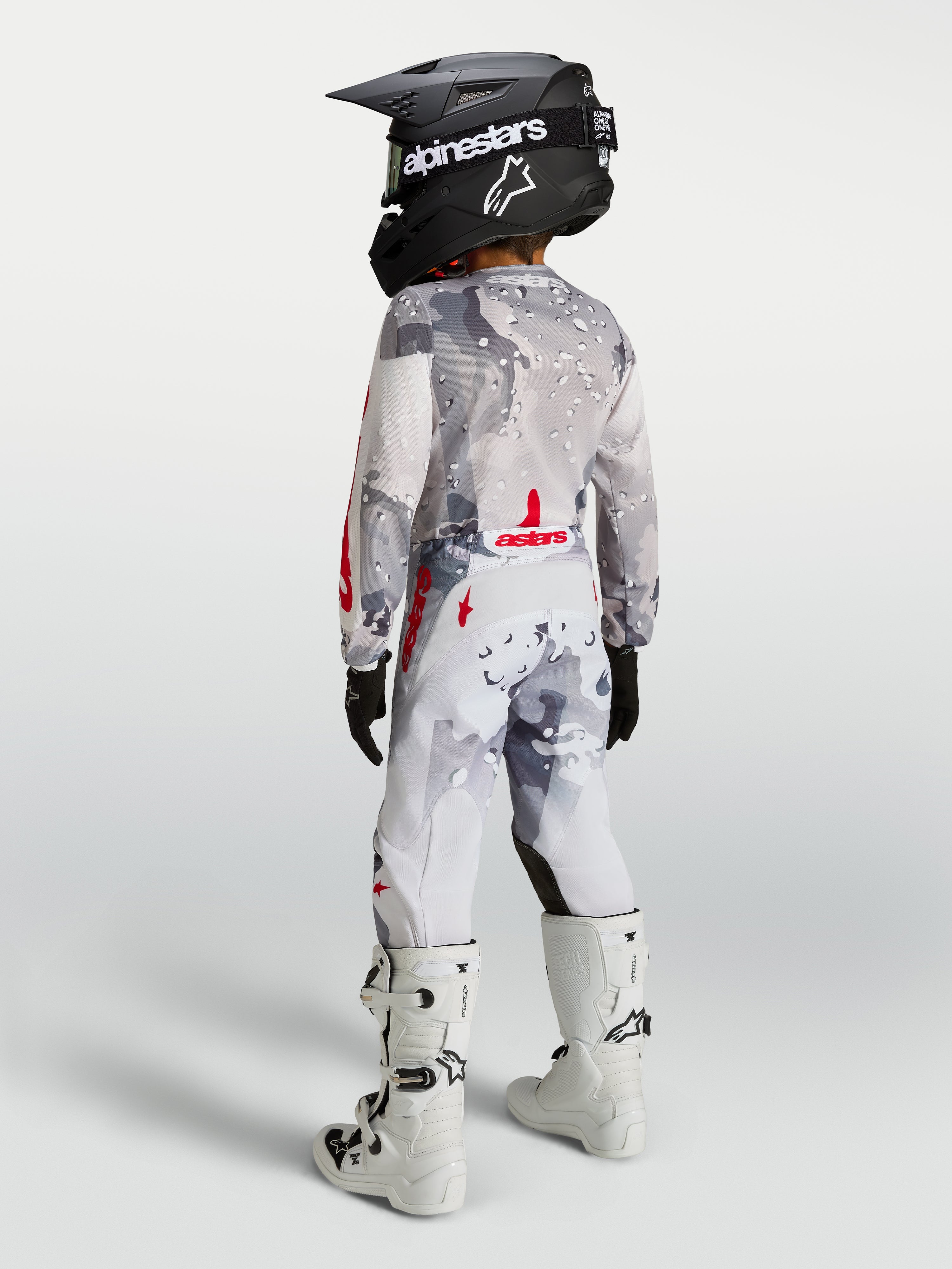 Alpinestars 2027 Youth Fluid Lone Gear Set, gray camo and white motocross apparel with red accents, on-model back view.