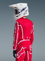 Alpinestars 2026 Youth Fluid Apex Jersey in Red and White, youth motocross jersey worn with matching gear and white helmet, back view showing athletic fit and white Alpinestars branding on sleeve and pants
