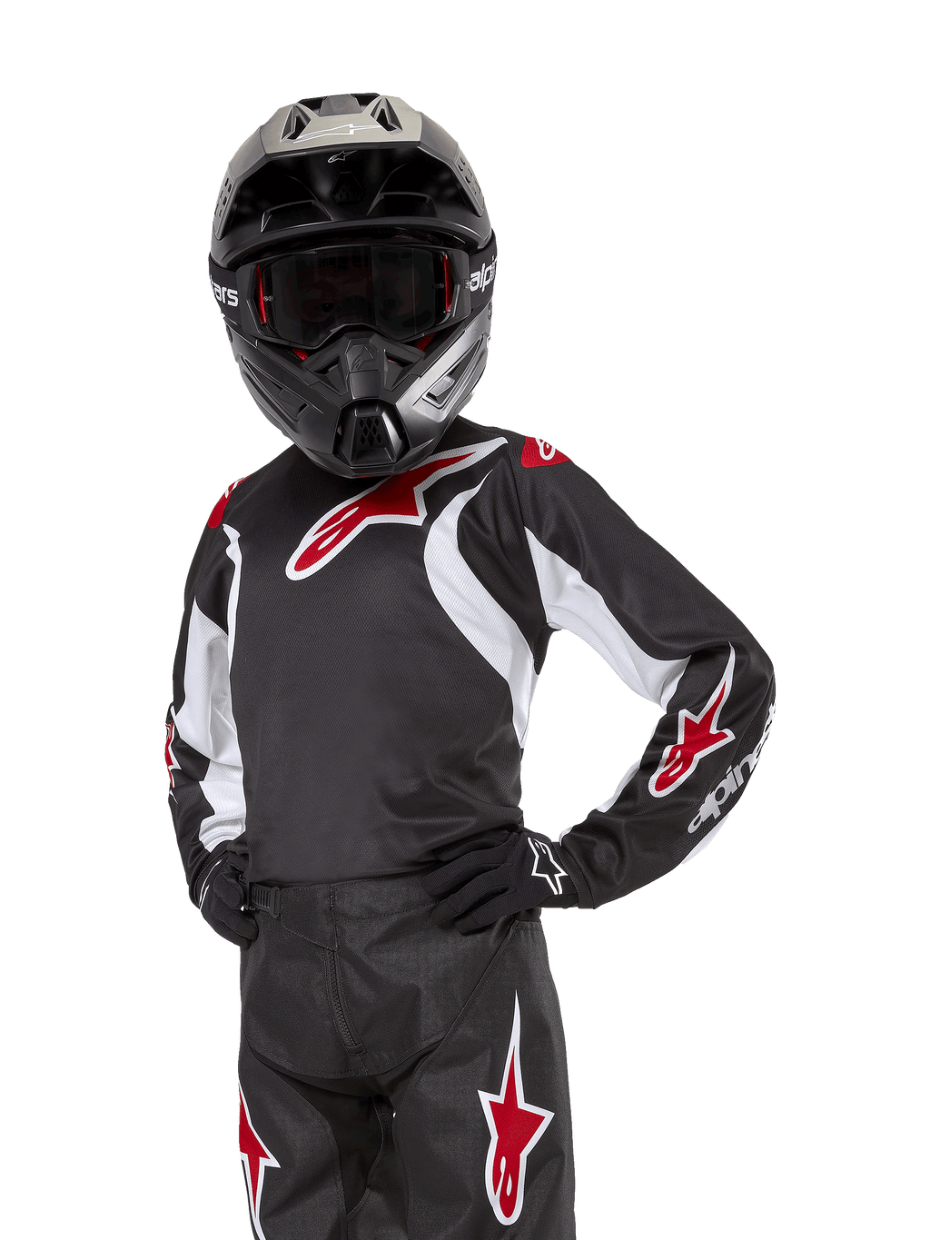 Jugend 2024 Racer Lucent Trikot, Motocross-Trikot, Schwarz, Weiß und Rot, getragen von einem jugendlichen Fahrer mit schwarzem Helm und passender Hose, mit roten Stern-Logos und weißen Grafikakzenten, Performance-Offroad-Bekleidung für Dirt-Bike-Rennen