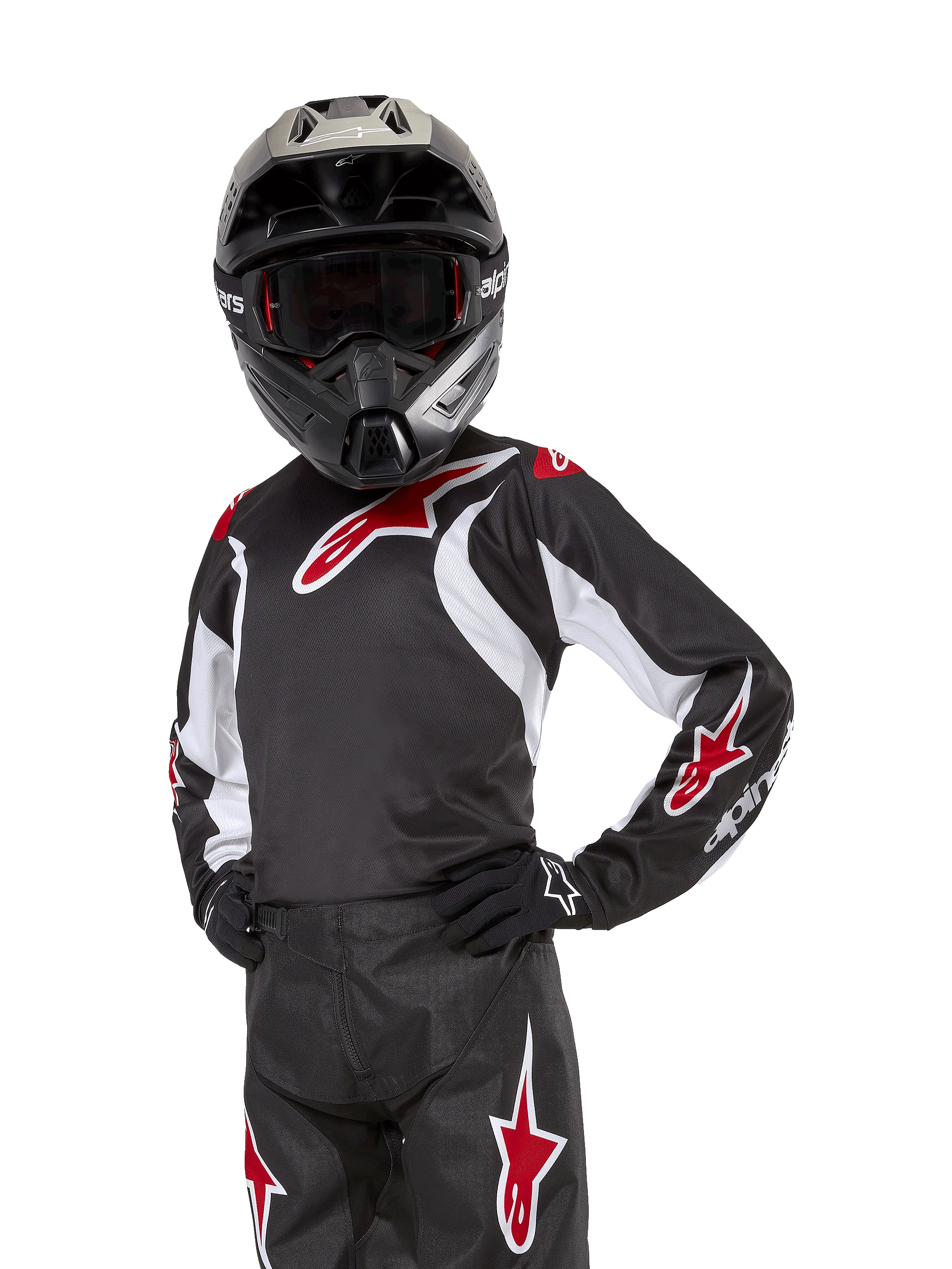 Jugend 2024 Racer Lucent Trikot, Motocross-Trikot, Schwarz, Weiß und Rot, getragen von einem jugendlichen Fahrer mit schwarzem Helm und passender Hose, mit roten Stern-Logos und weißen Grafikakzenten, Performance-Offroad-Bekleidung für Dirt-Bike-Rennen