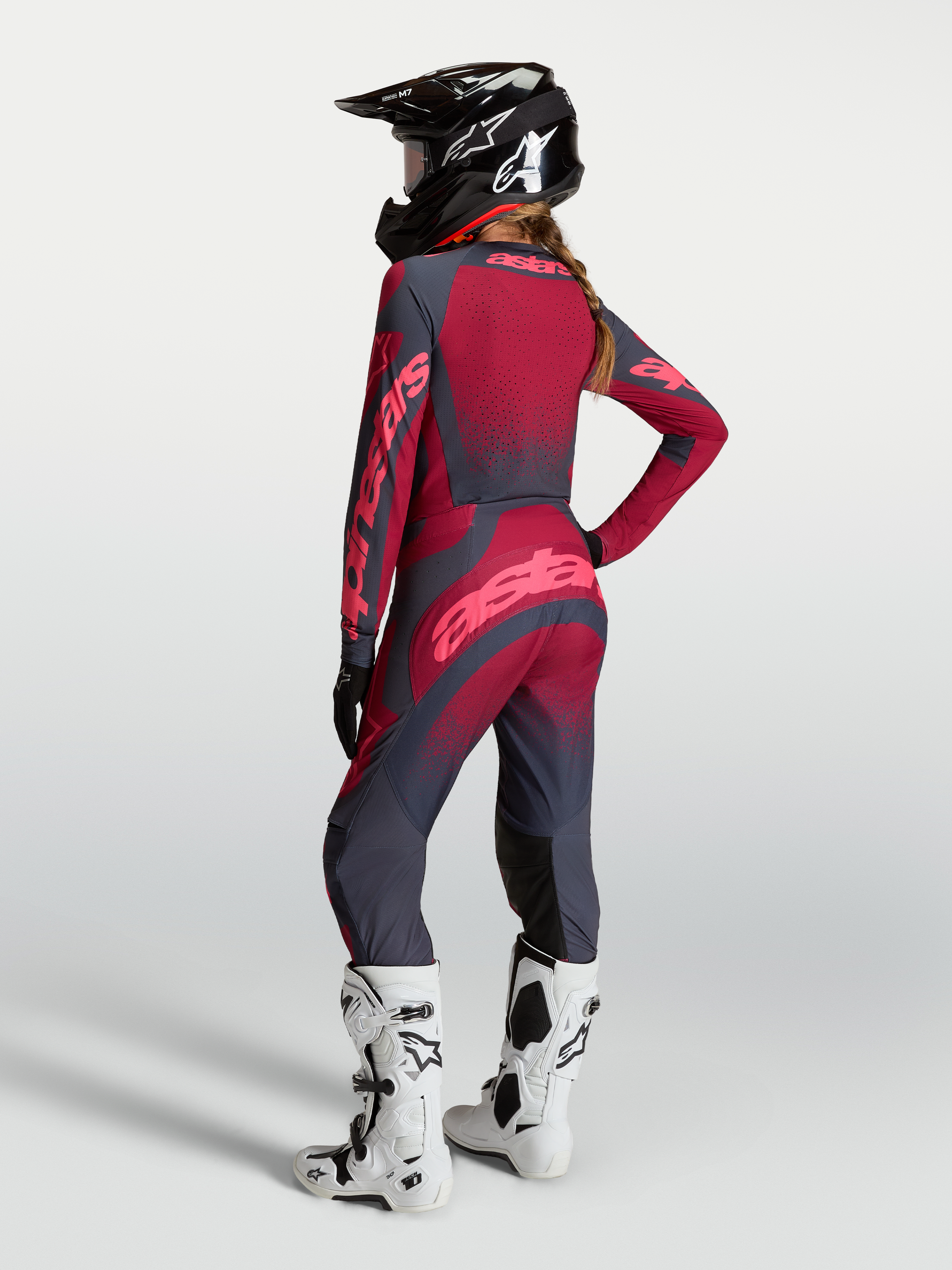 Alpinestars Stella Techstar Swan Trikot und Gear Set, Damen-Motocross-Kombi in Rot und Grau, Rückansicht mit Helm.