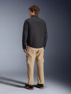 Alpinestars Bryon WR Overshirt, Black, rear view on model, paired with tan cargo pants and black sneakers, urban motorcycle jacket with waxed canvas texture and clean minimalist back design