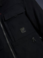 Alpinestars Bryon Water Resistant Overshirt, Black, close-up view of waxed canvas fabric, front zipper, chest cargo pocket with Alpinestars logo patch, and metal D-ring detail