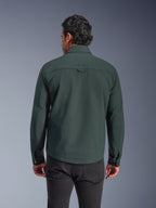Alpinestars Bryon Water Resistant Overshirt, Dark Emerald green, rear view on model, embroidered logo on the upper back, durable waxed canvas, urban motorcycle riding jacket paired with dark pants
