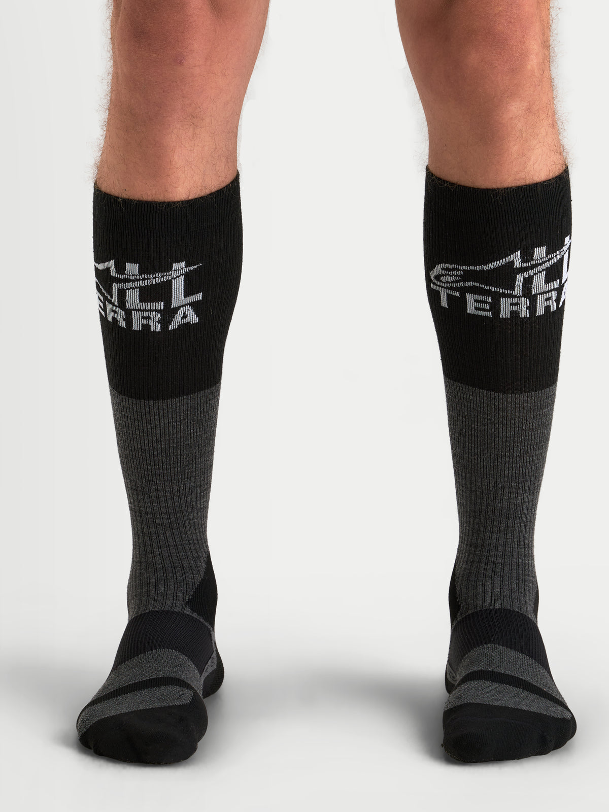 Alpinestars AT-8 Merino Socken, Herren-Adventure-Motorradsocken in Teergrau und Schwarz, kniehohe Thermo-Merinowoll-Funktionsbekleidung am Model mit geripptem Wadenbereich und verstärkten Polsterzonen