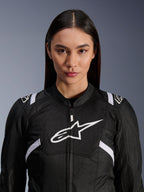 Female model wearing Alpinestars Stella T-SPS Air V2 Jacket, Women's Motorcycle Jacket, Black and White, featuring breathable mesh panels and a white Alpinestars logo on the chest, sporty design for road riding