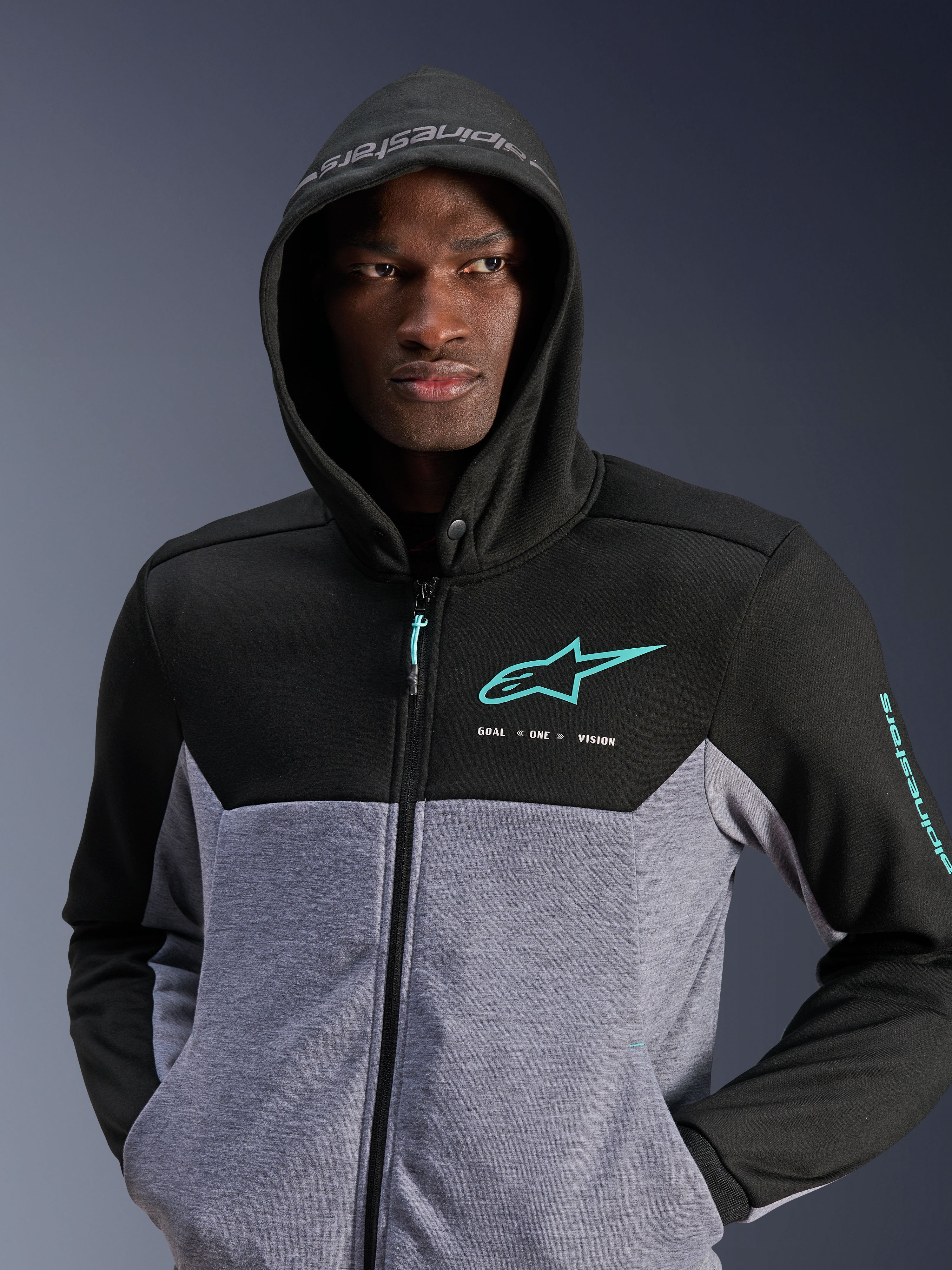Alpinestars Chrome V2 Sport Hoodie, Motorcycle Riding Hoodie, Black Gray Heather and Turquoise, two-tone tech fleece design with turquoise logo on chest and sleeve, 'GOAL ONE VISION' text, urban commuting gear