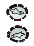 Alpinestars GP Tech Knee Sliders, Motorcycle Knee Protectors, White and Black, set of left and right sliders featuring white plastic shells with black Astar logos, hook-and-loop backing with 'ONE GOAL ONE VISION' text, high-performance racing gear