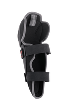 Alpinestars Bionic Action Knee Protector, Motocross Knee Guard, Black and Grey, interior view featuring dual elasticated strap system, foam padding, and ergonomic asymmetrical design for off-road riding