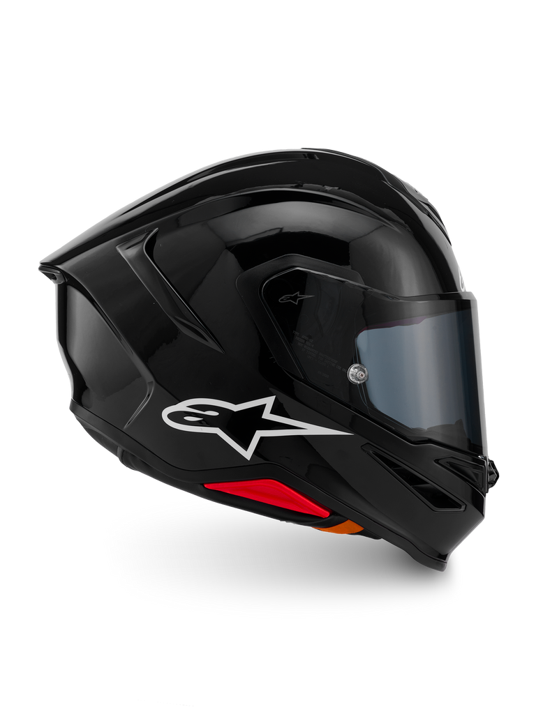 Alpinestars S-R7 Solid Helm, Integral-Motorradhelm, Schwarz glänzend, Profilansicht mit weißem A-Star-Logo, stromlinienförmige aerodynamische Außenschale mit integriertem Spoiler und roten Akzenten an der Unterseite, entwickelt für Rennsport- und Sport-Performance.