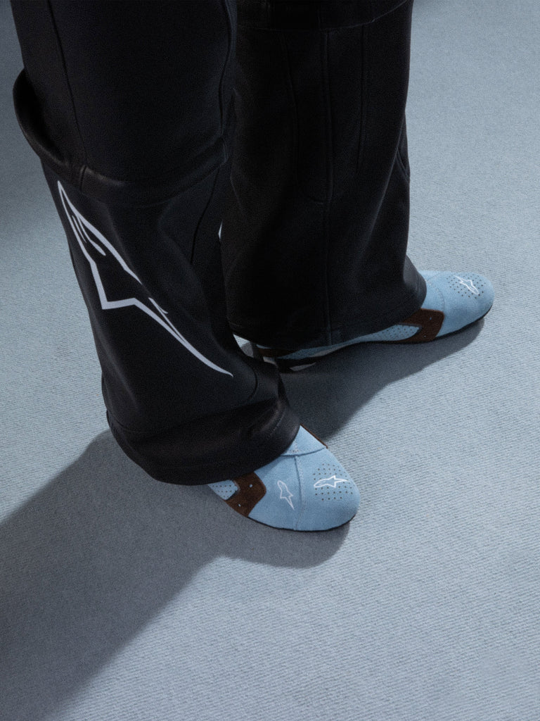 Alpinestars RSRV Starline Shoes, Light Blue Perforated Sneakers with Brown Straps, Casual Lifestyle Footwear, White Logo Detail, Worn with Black Leather Pants