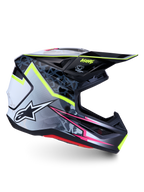 Alpinestars S-M7 Blaster Motocrosshelm in Schwarz und Grau mit neongelben und pinkfarbenen Akzenten, ECE 22.06 zertifiziert.