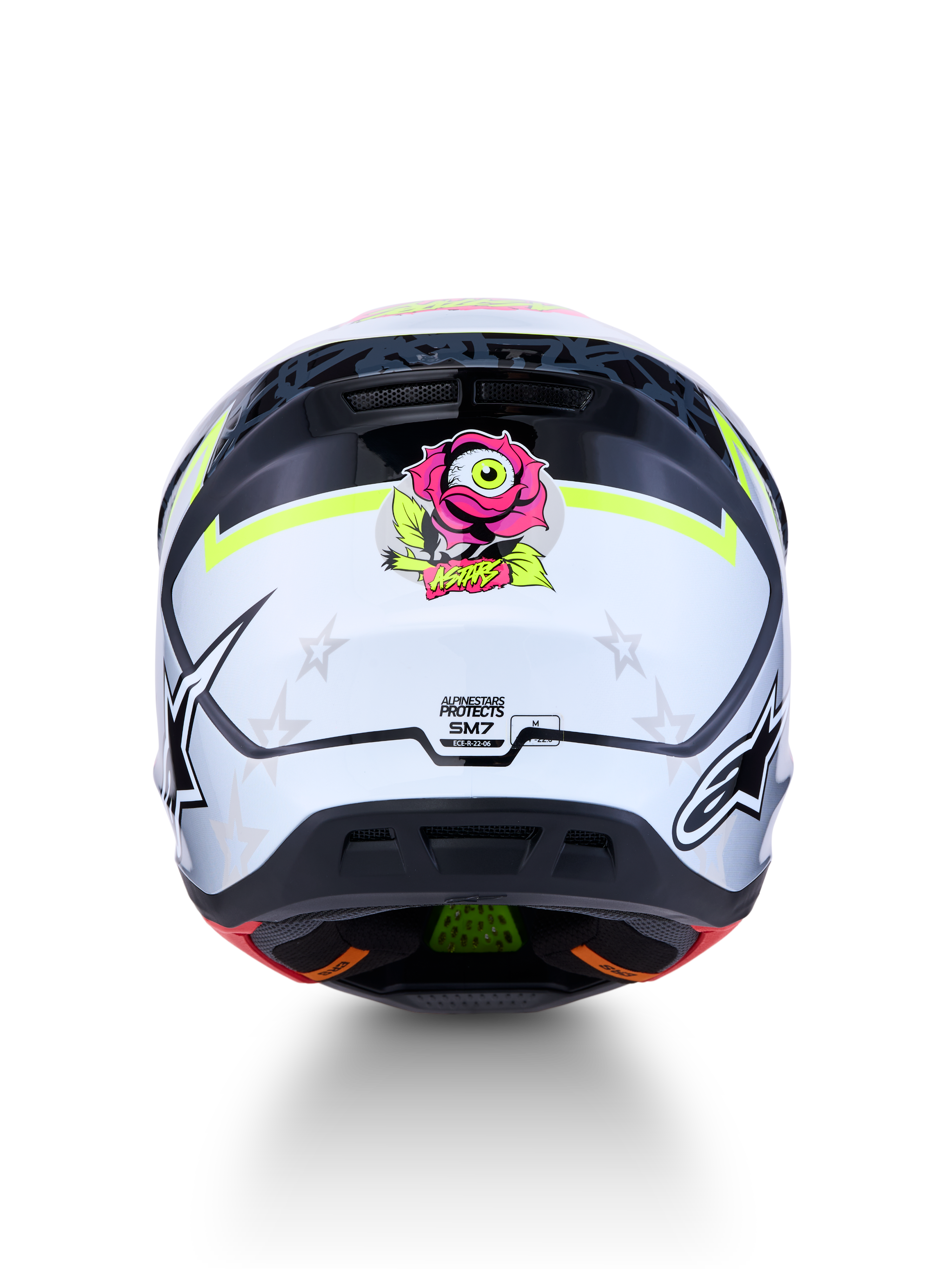 Alpinestars S-M7 Blaster Motocross-Helm, Rückansicht, Weiß-Schwarz mit gelben Akzenten, pinke Rosengrafik, ECE-zertifiziert.