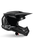 Alpinestars S-M3 Solid Helm, Motocross-Helm, Schwarz glänzend, Seitenprofilansicht mit weißem Stern-Logo, kantiges aerodynamisches Design mit Mesh-Belüftungsöffnungen und Visier, schützende Offroad-Rennsport-Kopfbedeckung