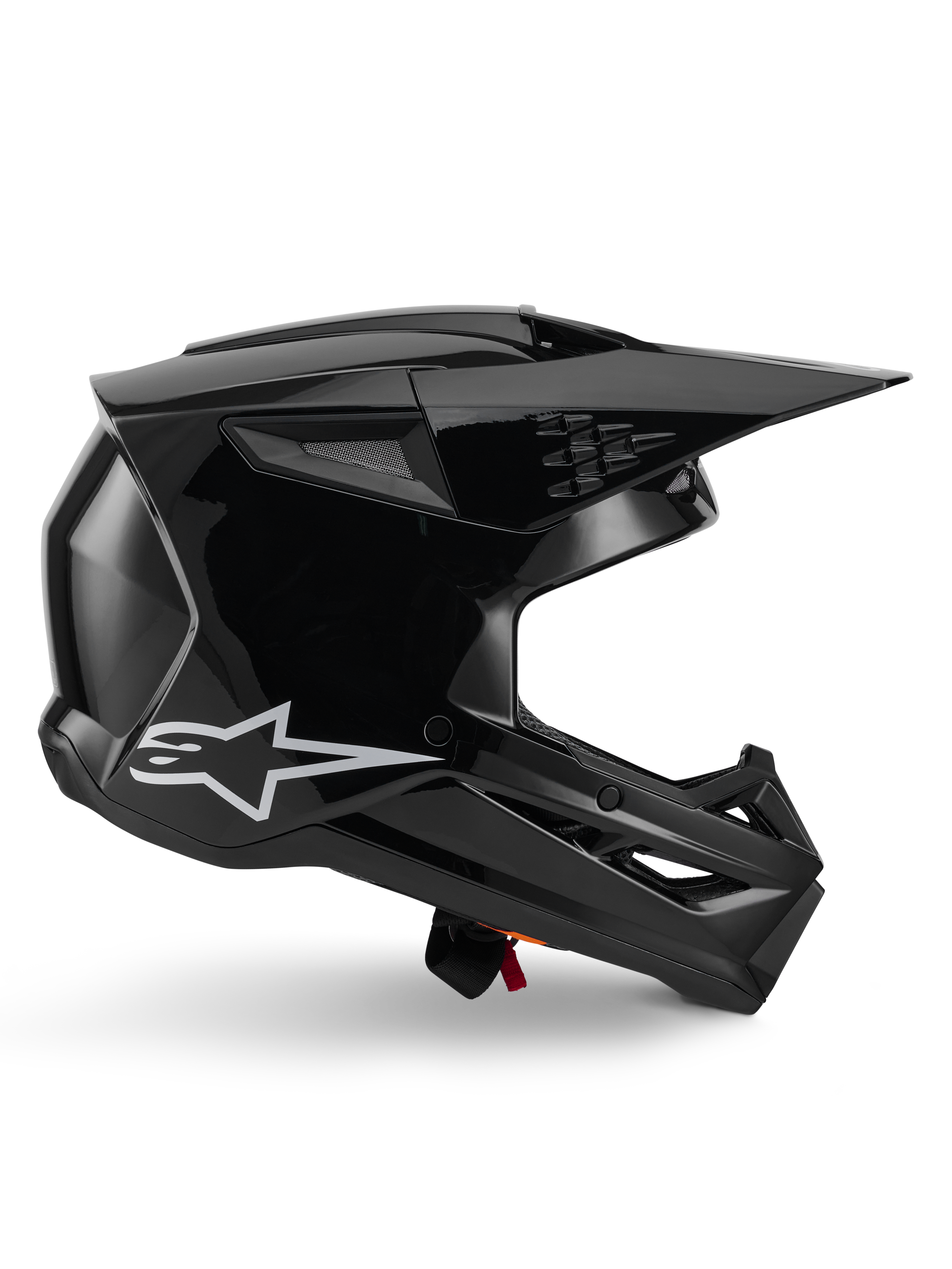 Alpinestars S-M3 Solid Helm, Motocross-Helm, Schwarz glänzend, Seitenprofilansicht mit weißem Stern-Logo, kantiges aerodynamisches Design mit Mesh-Belüftungsöffnungen und Visier, schützende Offroad-Rennsport-Kopfbedeckung