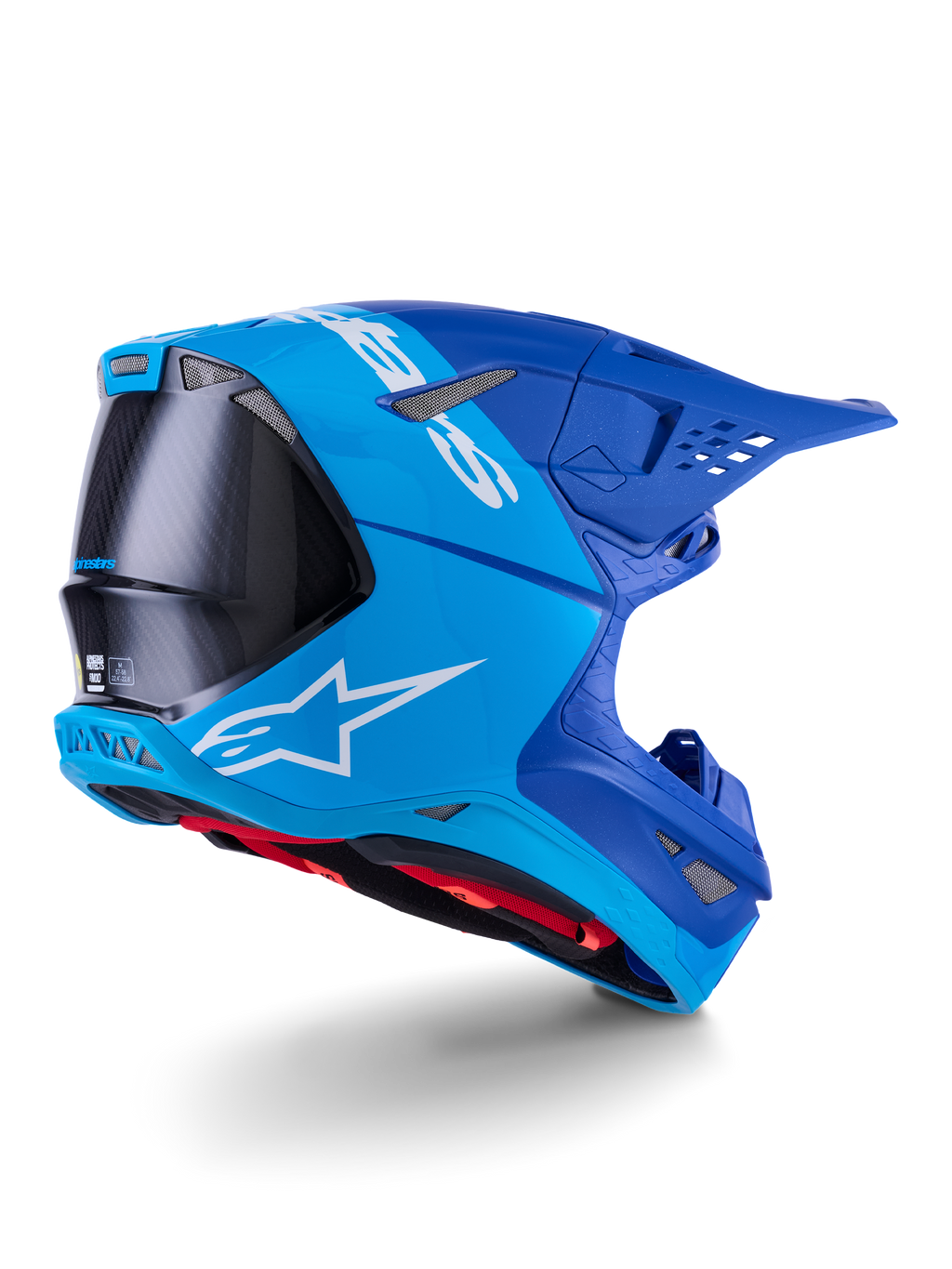 Alpinestars Supertech M10 Flood Helm, Motocross-Helm, Hellblau und Marineblau mit sichtbarer schwarzer Carbonfaser, Rückseiten-Profil mit Belüftungsöffnungen und weißem Logo, rotes Innenfutter, fortschrittliches aerodynamisches Design für Offroad-Performance