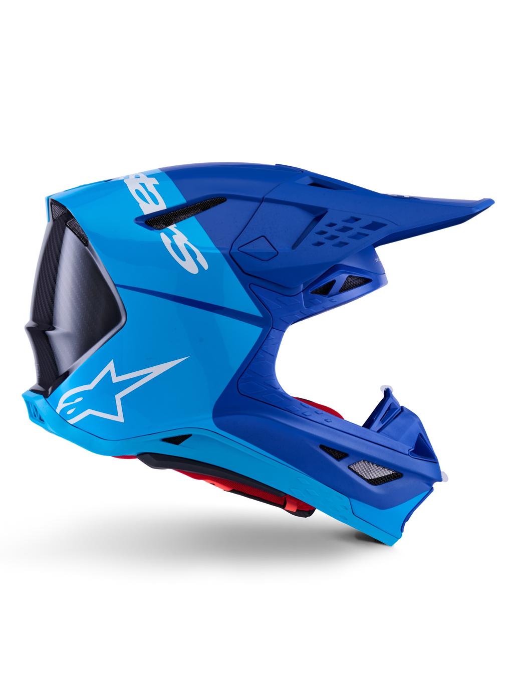 Alpinestars Supertech M10 Flood Helm, Motocross-Helm, Metallic-Blau und Mittelblau mit schwarzen Carbon-Akzenten, Seitenansicht, mit weißem Logo, aerodynamisches Design mit Belüftungsöffnungen, Details mit Carbonfaser-Textur, professioneller Schutz für den Offroad-Rennsport