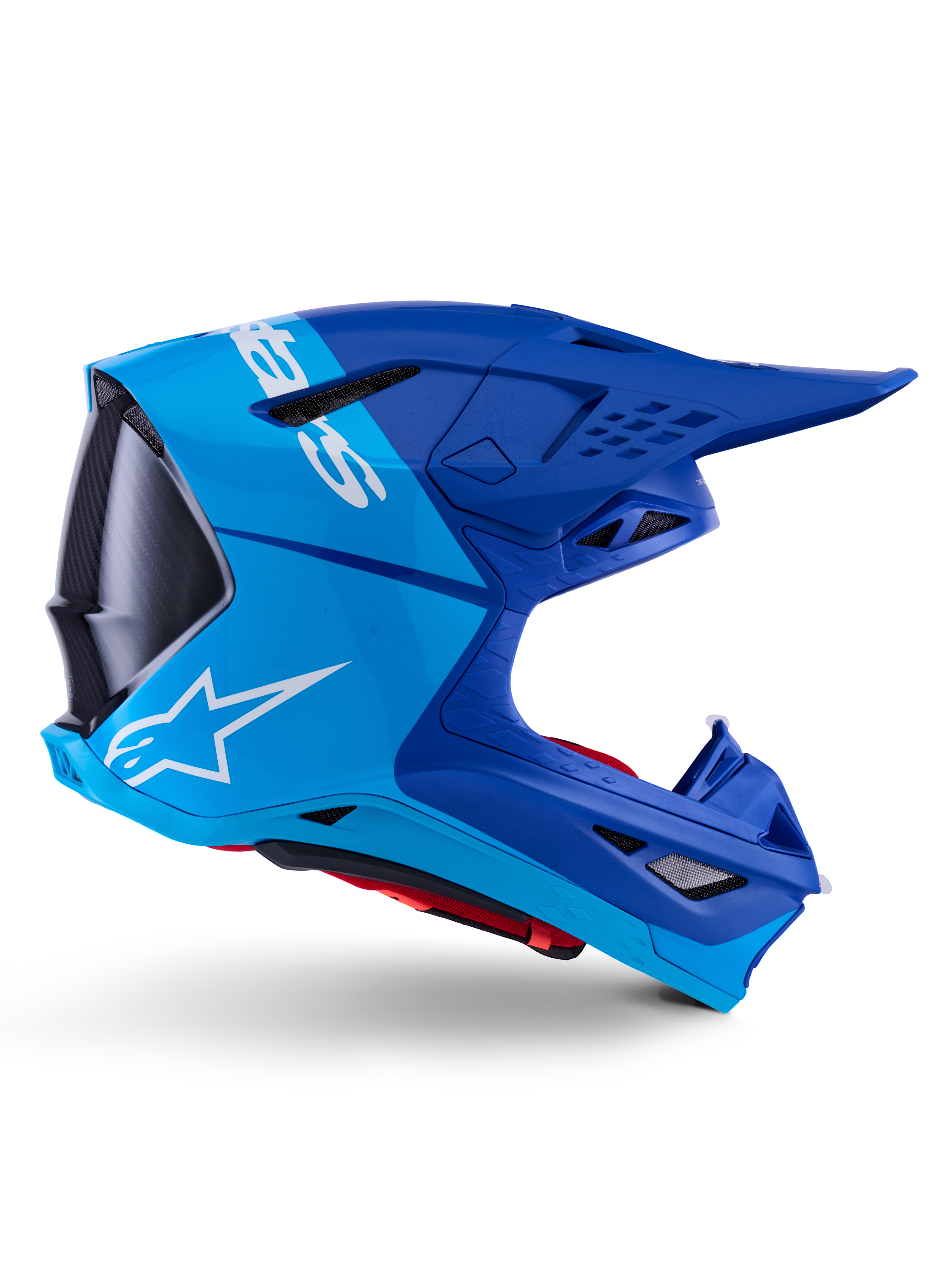 Alpinestars Supertech M10 Flood Helm, Motocross-Helm, Metallic-Blau und Mittelblau mit schwarzen Carbon-Akzenten, Seitenansicht, mit weißem Logo, aerodynamisches Design mit Belüftungsöffnungen, Details mit Carbonfaser-Textur, professioneller Schutz für den Offroad-Rennsport