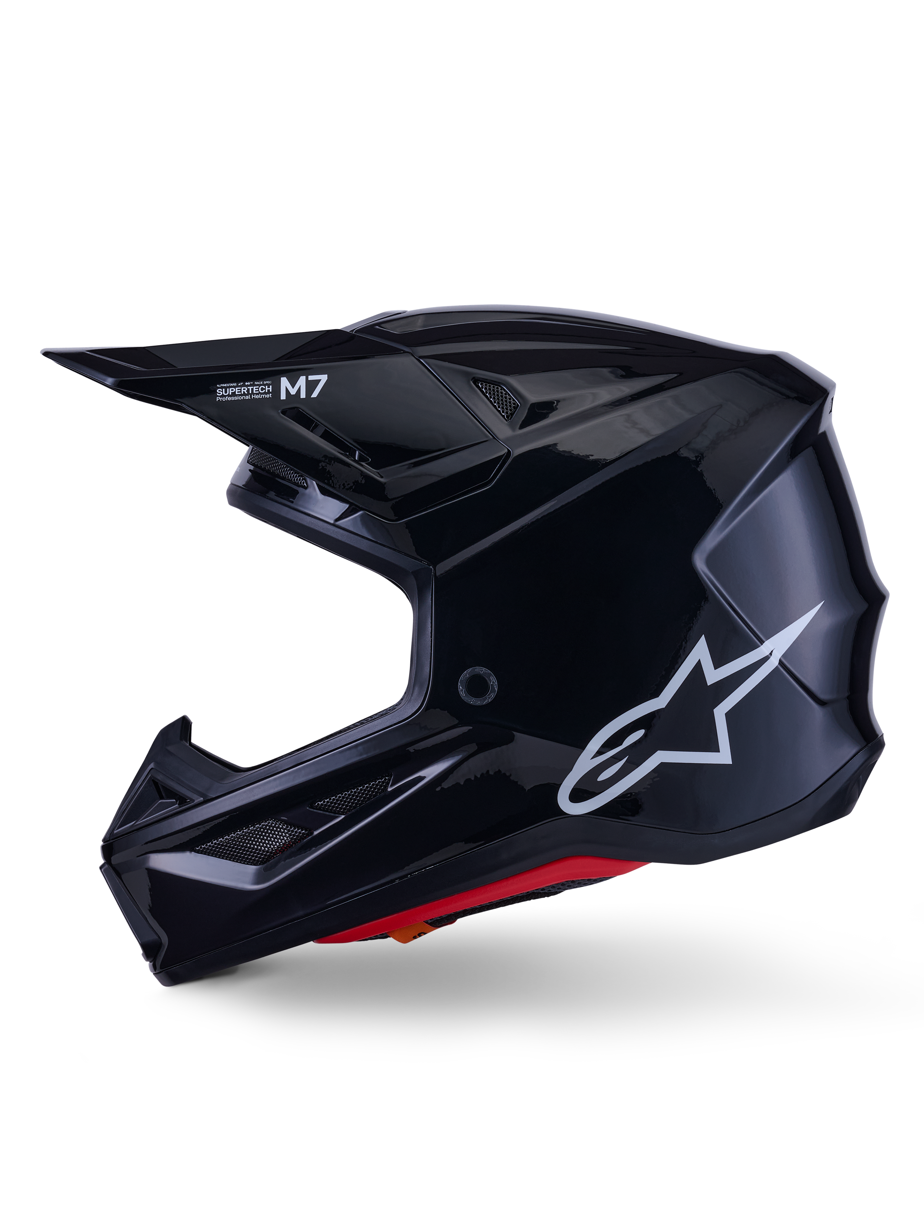 Alpinestars S-M7 Solid Helmet, Glossy Black Motocross Helmet, side profile showing white Alpinestars logo, aerodynamic shell with ventilation mesh and red interior padding, advanced off-road protection