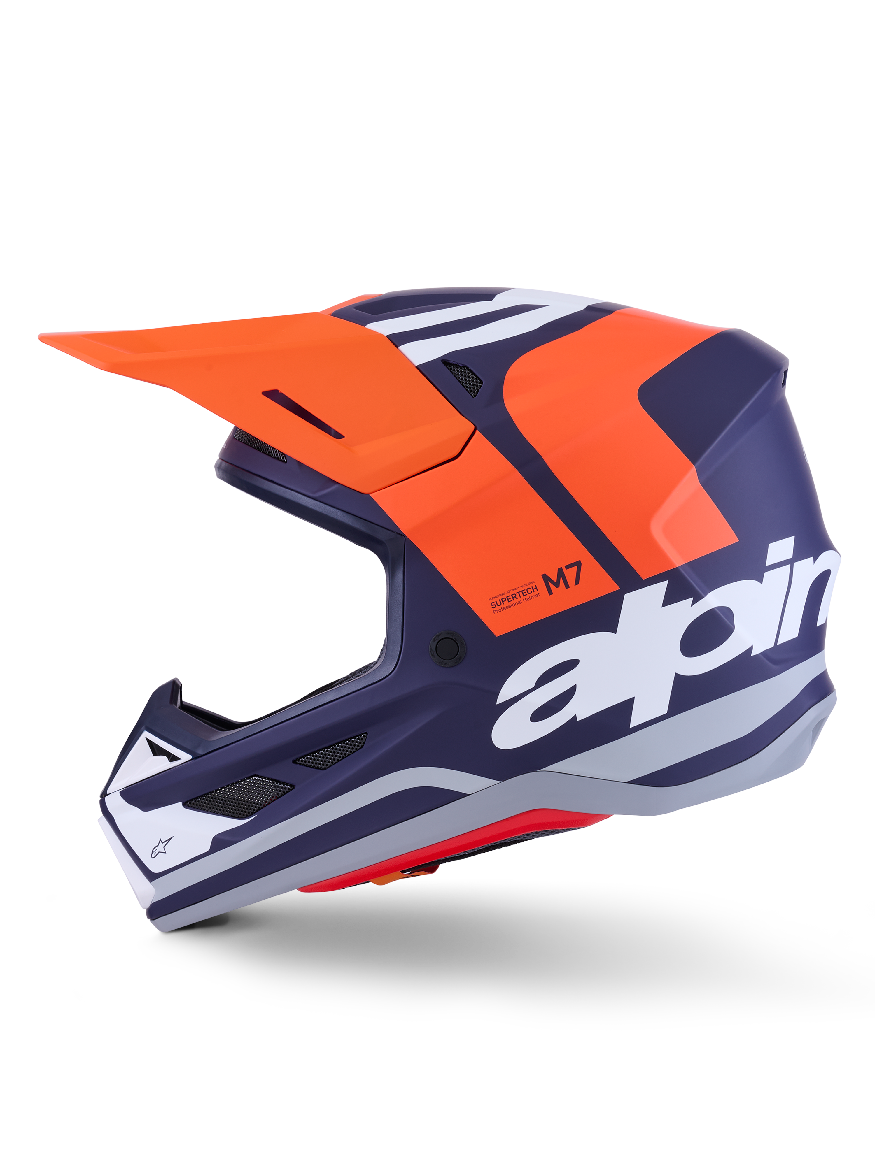 Alpinestars S-M7 Core Helm ECE 22.06, Seitenprofil, mattes Finish in Navyblau und Orange, großes weißes Branding an der Seite, aerodynamischer Motocross-Helm mit Schutzvisier