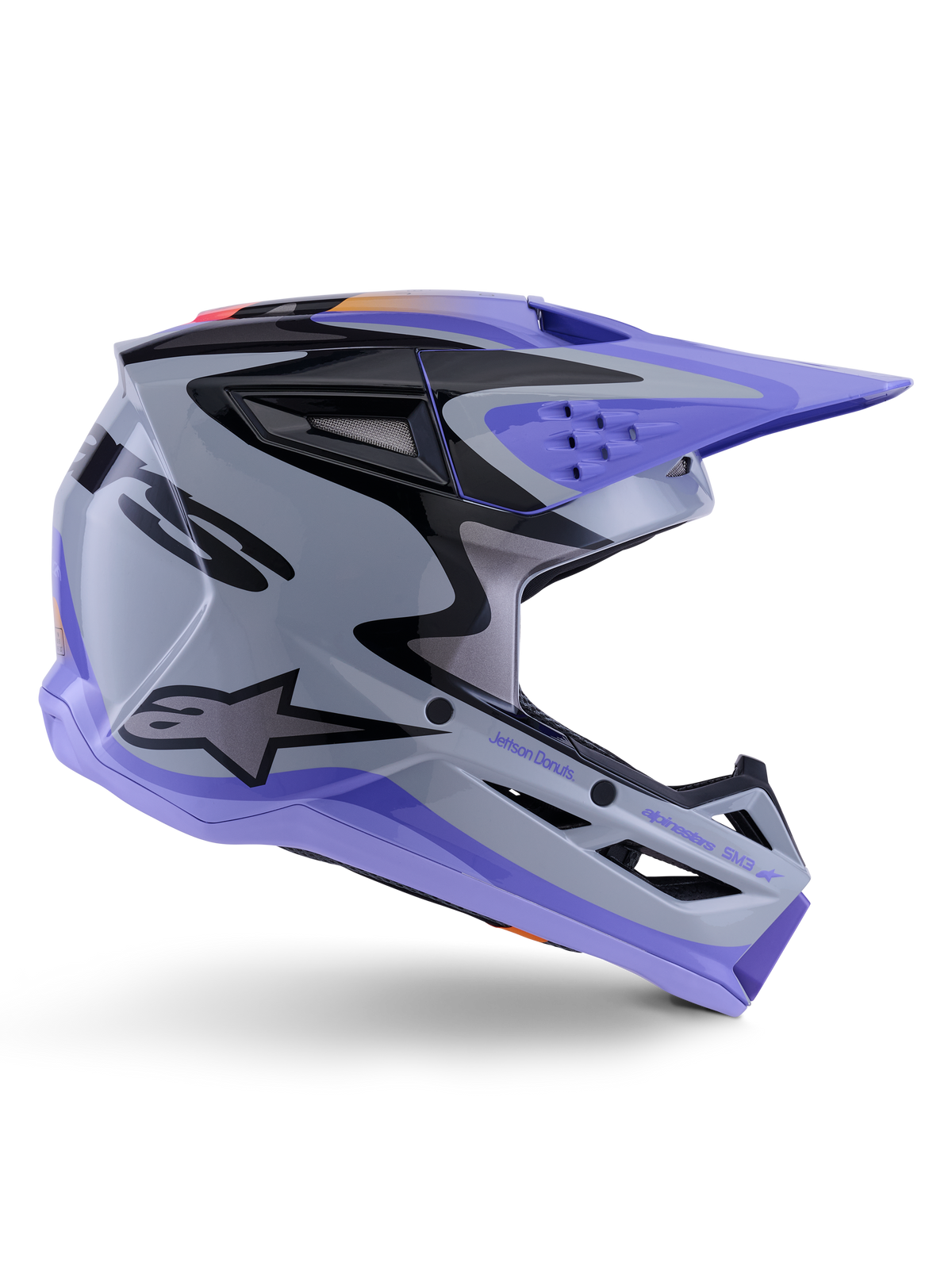 Alpinestars S-M3 Jettson Jugend-Helm, Motocross-Helm, Grau, Lila und Schwarz glänzend, Seitenprofil mit scharfen, kantigen Grafiken und 'Jettson Donuts'-Branding, aerodynamisches Schalendesign mit Belüftungsöffnungen und Alpinestars-Logo, hochleistungsfähige Offroad-Schutzausrüstung für Jugendliche