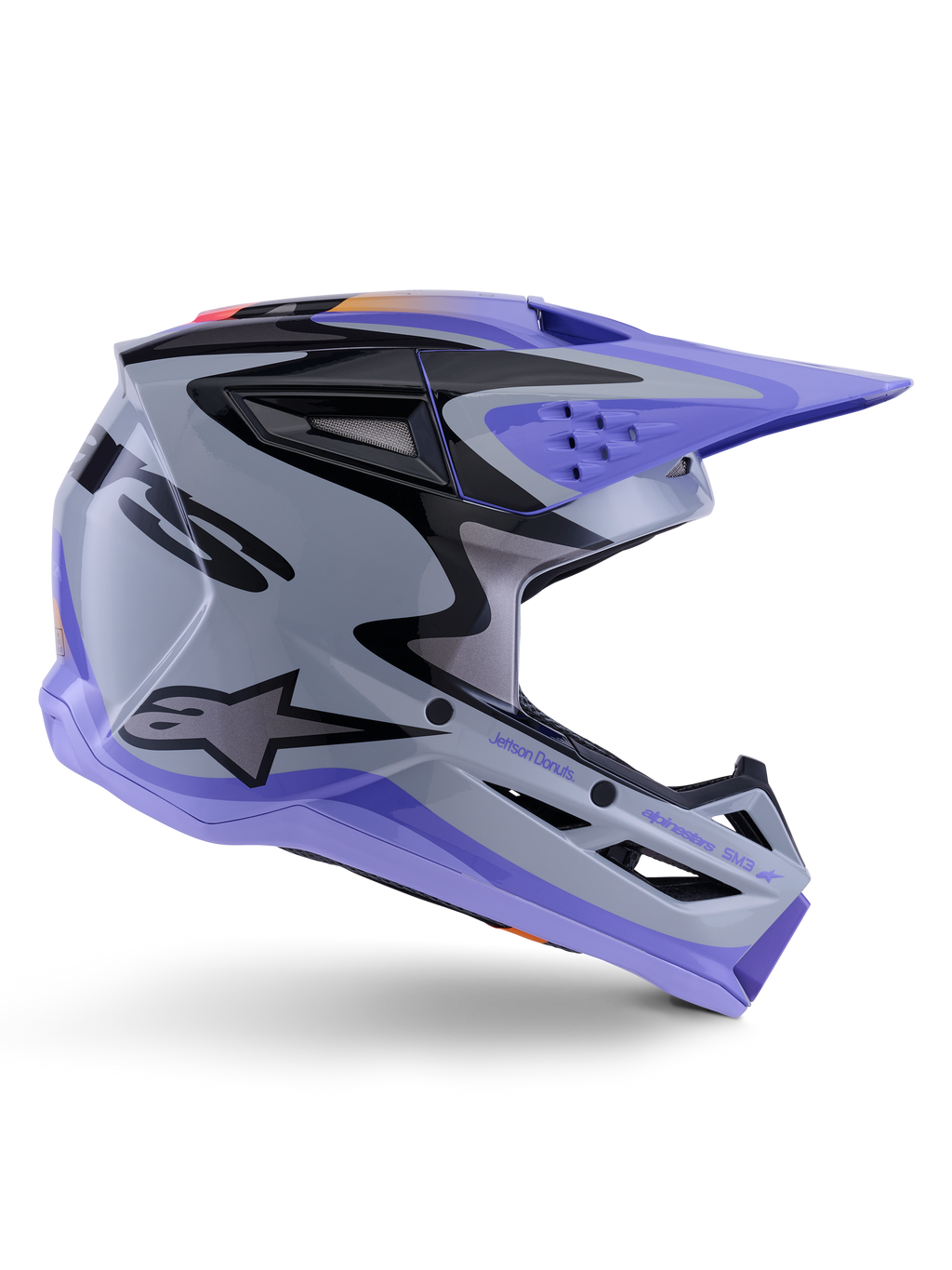 Alpinestars S-M3 Jettson Jugend-Helm, Motocross-Helm, Grau, Lila und Schwarz glänzend, Seitenprofil mit scharfen, kantigen Grafiken und 'Jettson Donuts'-Branding, aerodynamisches Schalendesign mit Belüftungsöffnungen und Alpinestars-Logo, hochleistungsfähige Offroad-Schutzausrüstung für Jugendliche