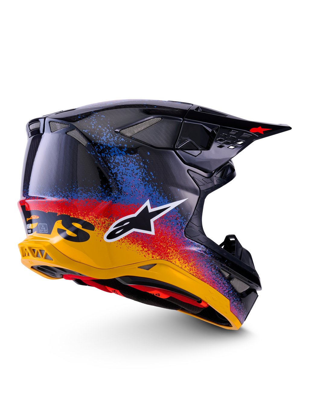 Alpinestars Limited Edition Supertech M10 Black Hole Helm, Motocross-Helm, Black Burst Glossy mit einem leuchtenden, gesprenkelten Farbverlauf von Gelb über Rot nach Blau, leichte Carbon-Schale mit weißem A-Star-Logo und integrierten Mesh-Belüftungsöffnungen