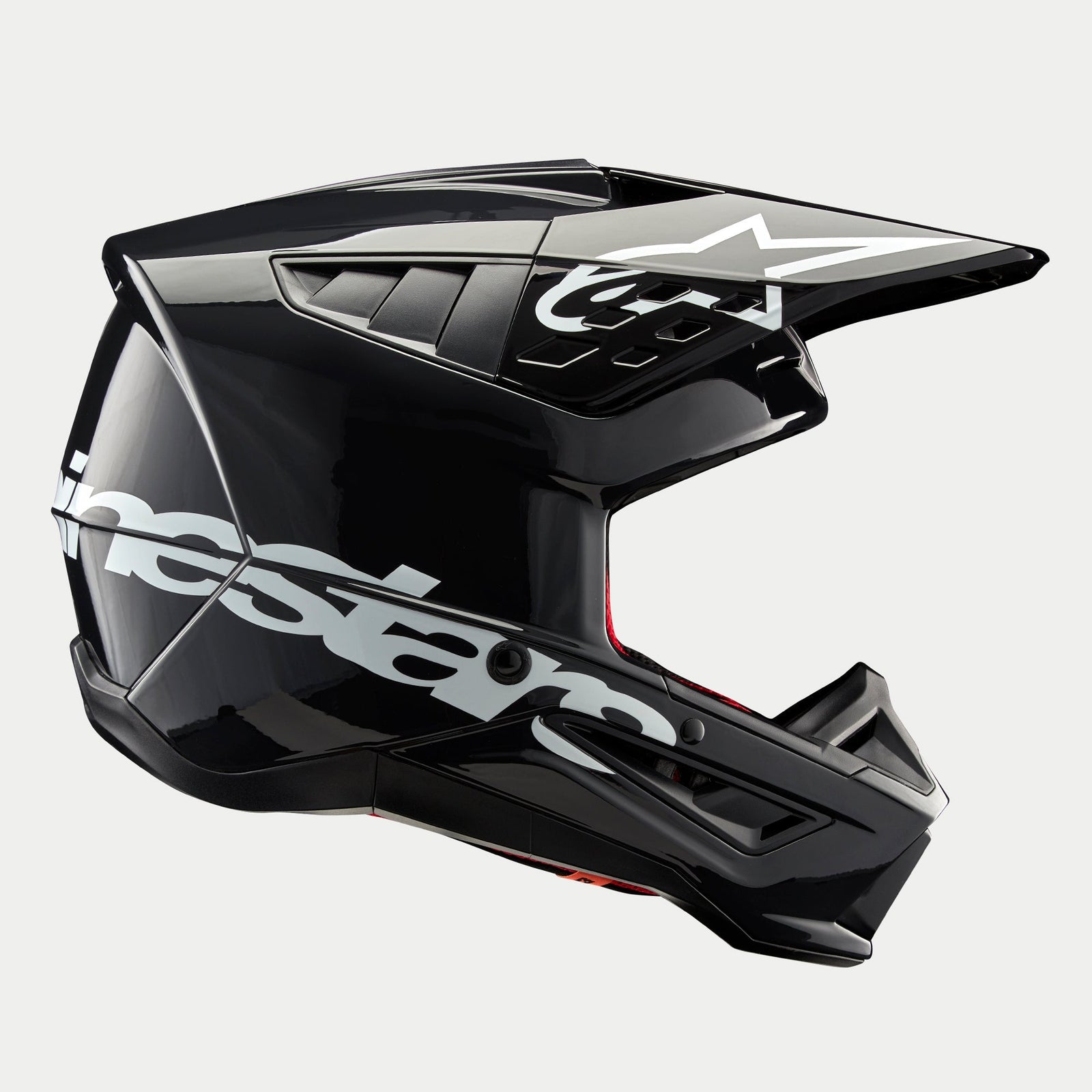 Alpinestars S-M5 Corp Helmet, Motocross Helmet, Dark Gray Glossy, side profile view with large white Alpinestars logo, white star logo on the visor, sleek aerodynamic vents, glossy finish, off-road racing protection