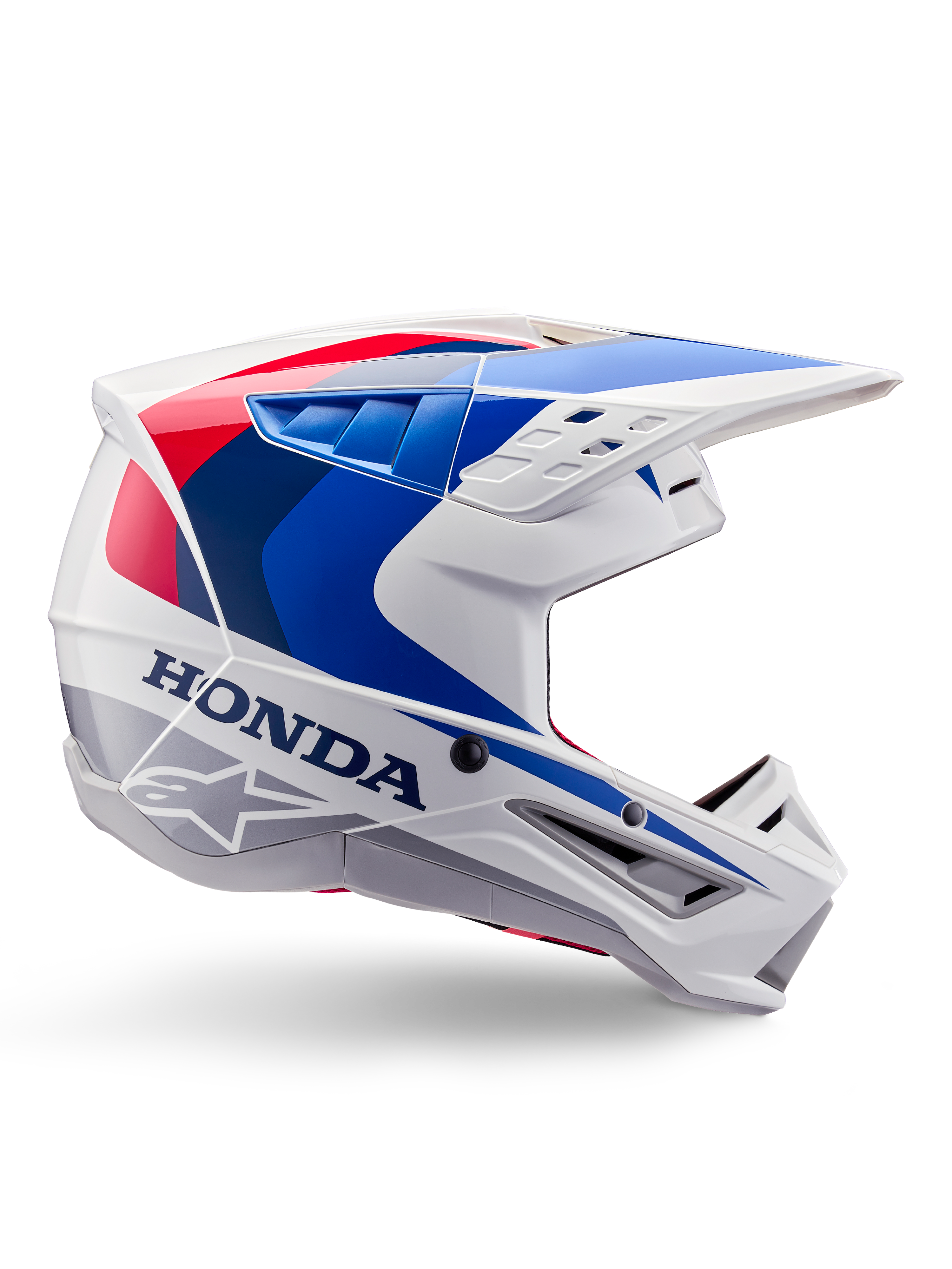 Alpinestars Honda S-M5 Helm ECE, Motocross-Helm, Weiß, Blau und Rot, Seitenprofil-Ansicht, aerodynamisches Design mit integriertem Visier, mehrere Belüftungsöffnungen, glänzendes Finish, markantes Honda-Branding und Alpinestars-Logo