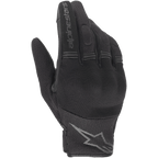 Alpinestars Stella Copper Damen-Handschuhe, schwarze Motorradhandschuhe, Handrückenansicht mit Mesh- und Textilkonstruktion, gerippte Akkordeon-Einsätze an den Fingern, Alpinestars-Schriftzug auf dem Zeigefinger und Stern-Logo am Handgelenk, leichtes urbanes Design